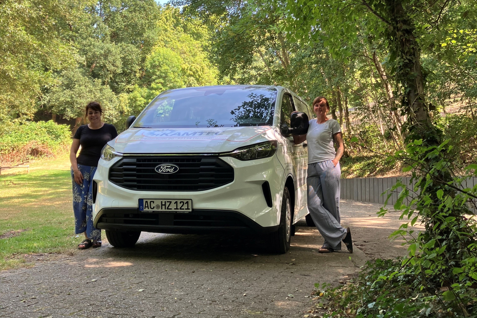 Stascha Löffler von der Mobilen Jugendarbeit (li.) und Britta Sachse vom Abenteuerspielplatz Broichbachtal (re.) neben dem neuen Fahrzeug.