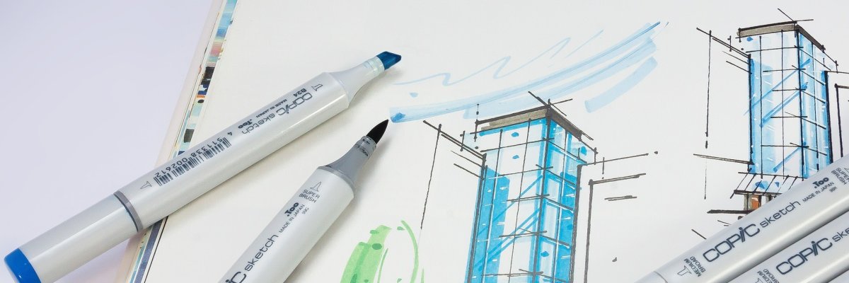 Foto: Zeichnung eines Gebäudes Auf dem Foto ist die Zeichnung eines Gebäudes zu sehen. Auf der Zeichnung liegen ein paar Stifte