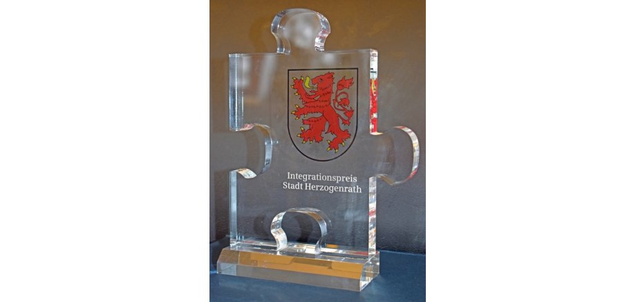 Integrationspreis Herzogenrath, Trophäe aus Glas, Puzzlestück mit Herzogenrather Wappen